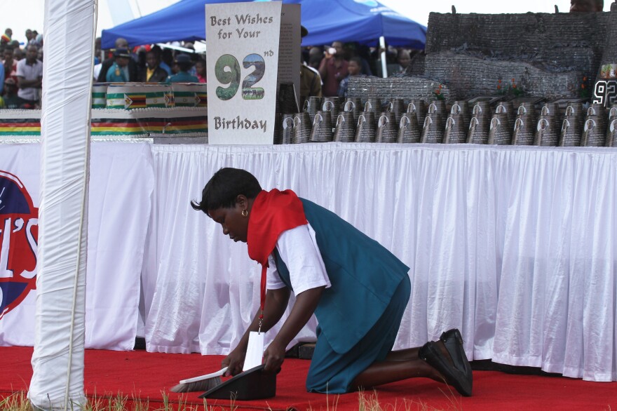 A woman cleans the carpet during birthday celebrations for Zimbabwean President Robert Mugabe on Saturday in Masvingo, about 300 kilometres south of Harare, Zimbabwe.