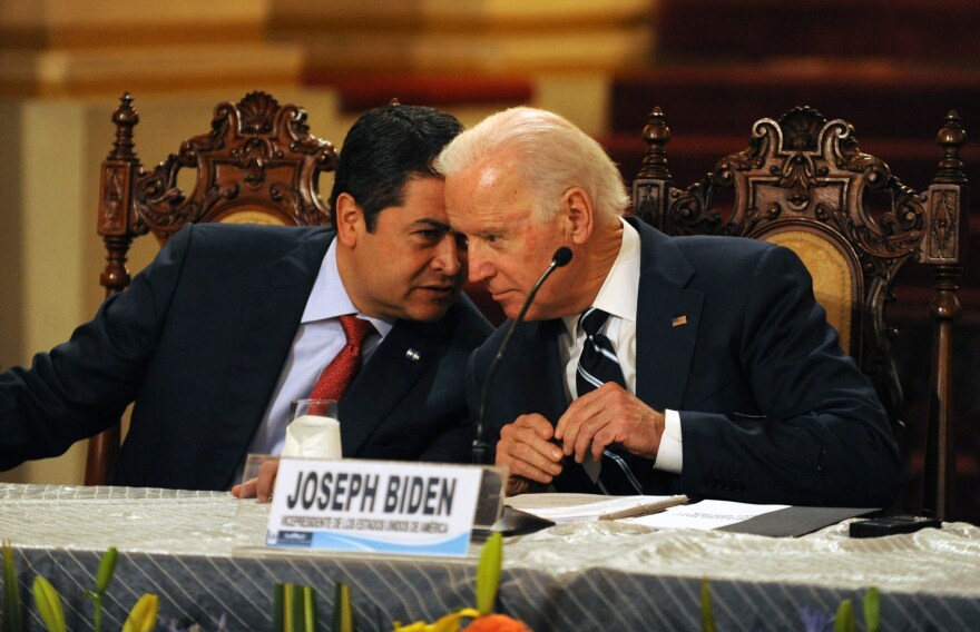 Honduran President Juan Orlando Hernández (left) speaks with then-Vice President Biden during a news conference in Guatemala City on March 2, 2015. Leaders from Guatemala, El Salvador and Honduras were meeting with Biden for two days of talks about child migrants entering the United States.