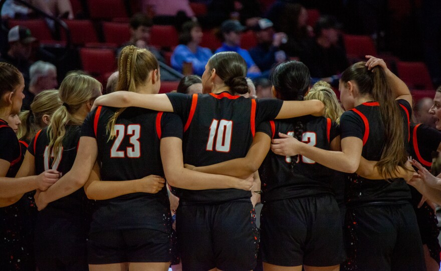 Girls high school basketball players inside an arena