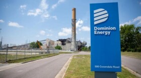Photo by Crixell Matthews, VPM News. A sign outside of Dominion Energy's power station in Chester, Virginia.