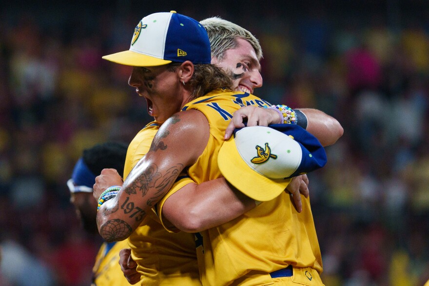 Shortstop Ryan Cox hugs third baseman KJ Jackson during a baseball game between the Savannah Bananas and the Party Animals at Busch Stadium on Friday, July 18, 2025, in downtown St. Louis.