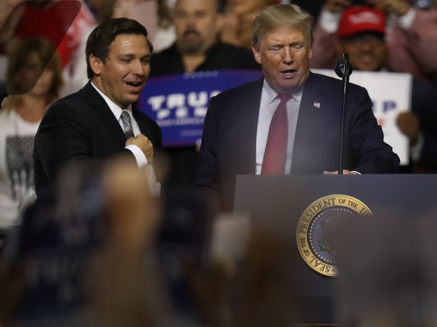 President Donald Trump stands with GOP Florida gubernatorial candidate Ron DeSantis during the president's Make America Great Again Rally at the Florida State Fair Grounds Expo Hall on July 31, 2018 in Tampa.