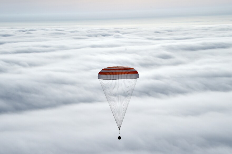 The Soyuz TMA-18M capsule carries International Space Station crew members Scott Kelly, Mikhail Kornienko and Sergei Volkov before landing in Kazakhstan.