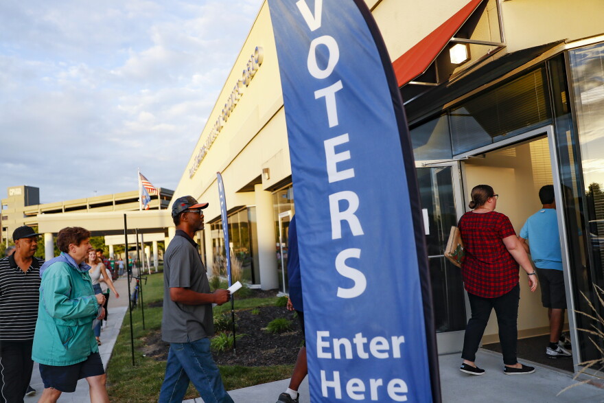 Voters enter the Hamilton County Board of Elections on the first day of early voting, Wednesday, Oct. 10, 2018, in Cincinnati. 