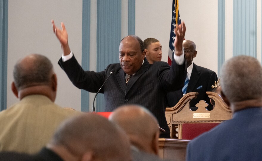 Pastor Reginald Davis leads First Baptist Church congregants in prayer during Sunday service on May 24, 2026.