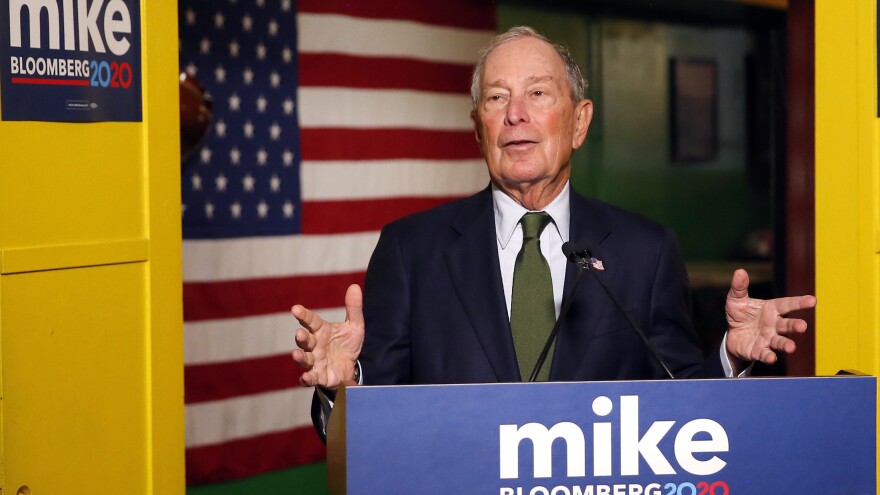 Former New York Mayor Mike Bloomberg speaks to the media in Phoenix. Bloomberg, who's running for president, is spending millions on TV ads but not competing in Iowa or New Hampshire.