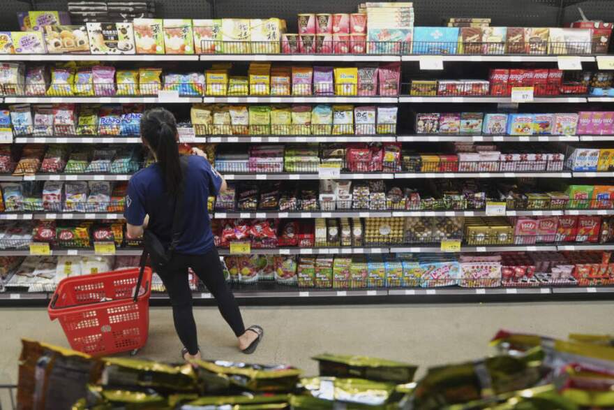 A customer buys Chinese made ginger candy at an Asian grocery store in Los Angeles, April 7, 2025. (Damian Dovarganes/AP)