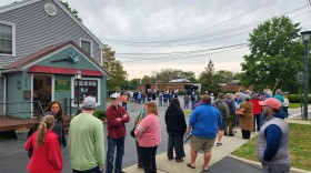 Voters line up outside the Manlius town hall to cast their ballot