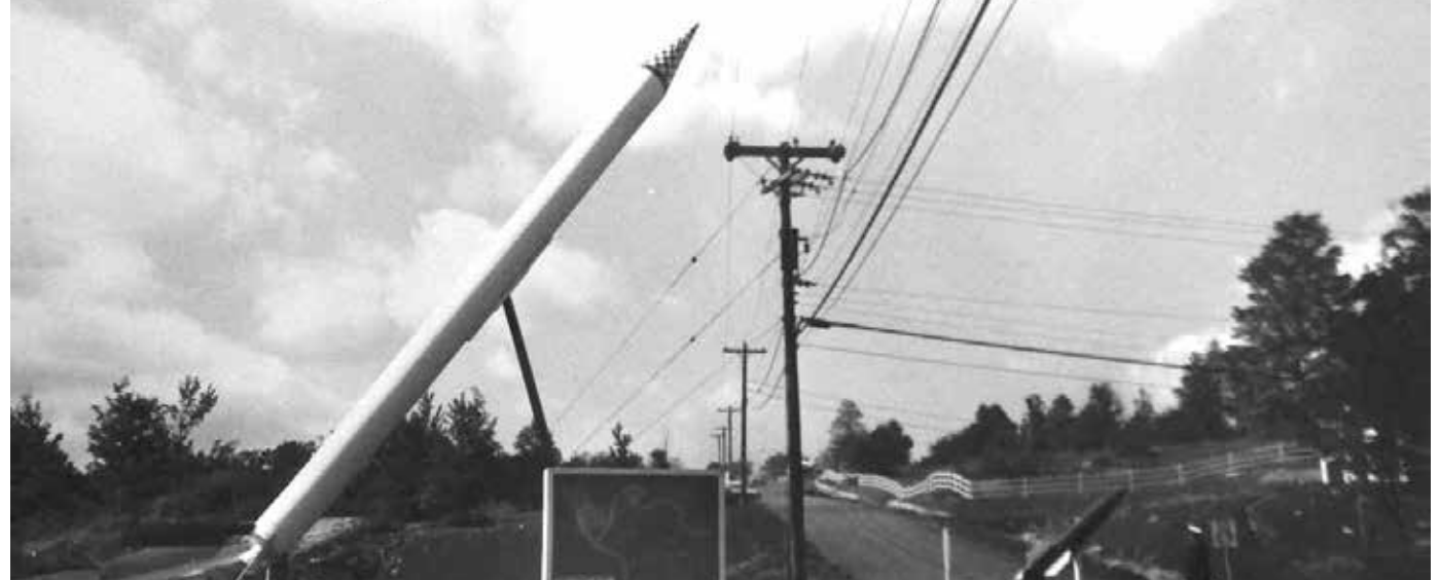 A black and white picture of a large gun pointed towards the sky