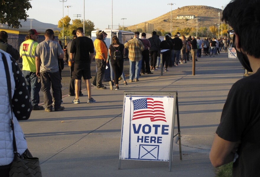 FILE - People wait to vote in-person at Reed High School in Sparks, Nev., prior to polls closing on Nov. 3, 2020.