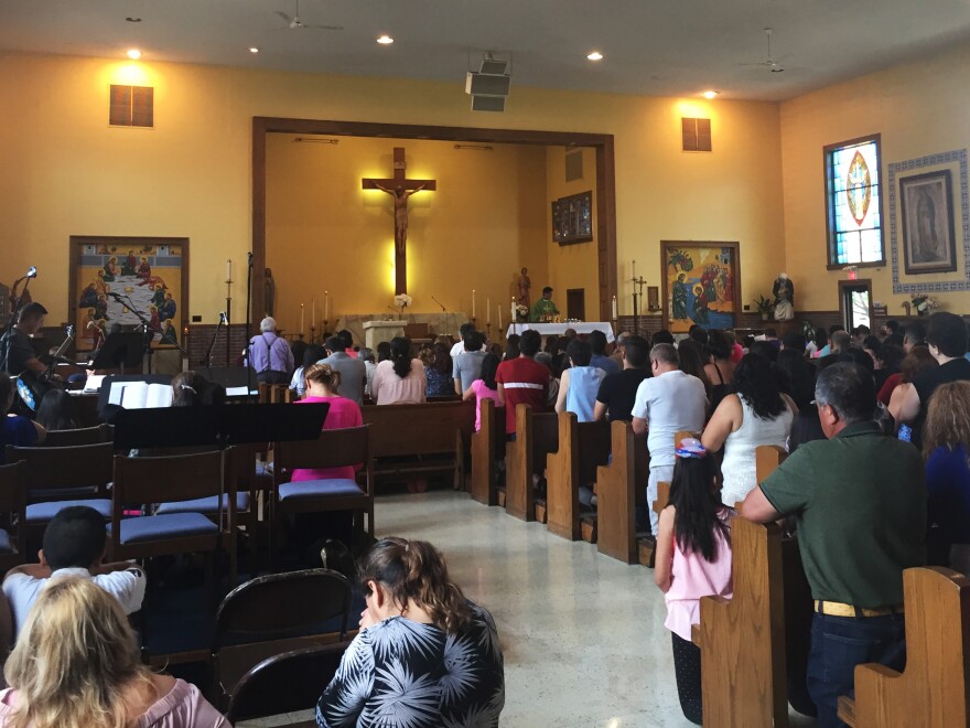 Worshippers at St. Alexis pray during a Spanish-language Sunday Mass.