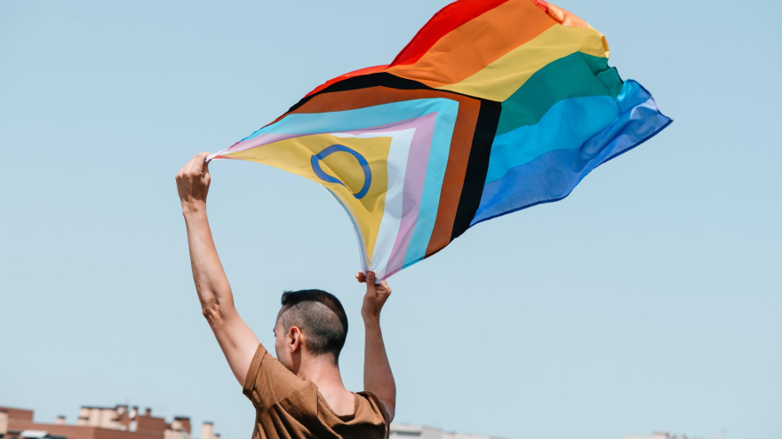 A gay pride flag waved in the air.