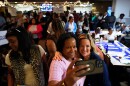 Michigan Secretary of State Jocelyn Benson, right center, the Democratic gubernatorial nominee, poses for a photo with Rose Dady, at a campaign event at the Trade Union Leadership Council in Detroit, Tuesday, Aug. 18, 2026. (AP Photo/Paul Sancya)