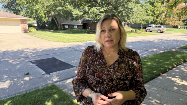 Ukrainian immigrant Tetiana stands on her street in Kettering, Ohio, discussing her struggles staying safely in the U.S. while her hometown suffers through war with Russia