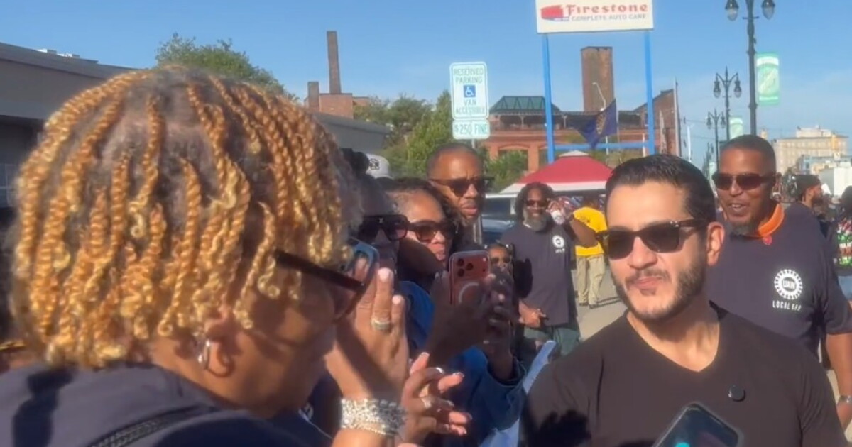 Michigan politicians spent Monday shaking hands with voters, a day after an armed man charged at an Ohio candidate