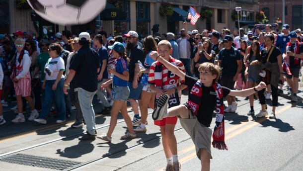 A child rooting for the U.S. men's soccer team kicks an inflatable soccer ball.