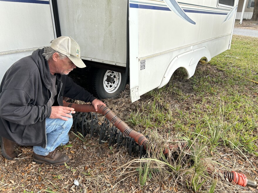 Robert Kritzrow, 62, explains how his RV connects to the septic system in the ground. Residents do not have to do any maintenance of the septic tank itself.