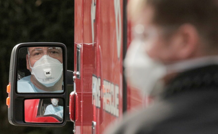 A medic drives an ambulance at the Life Care Center of Kirkland, Wash., which has been linked to most of the deaths in the U.S. from the coronavirus disease COVID-19 so far.
