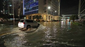 SUV driving through a flooded street
