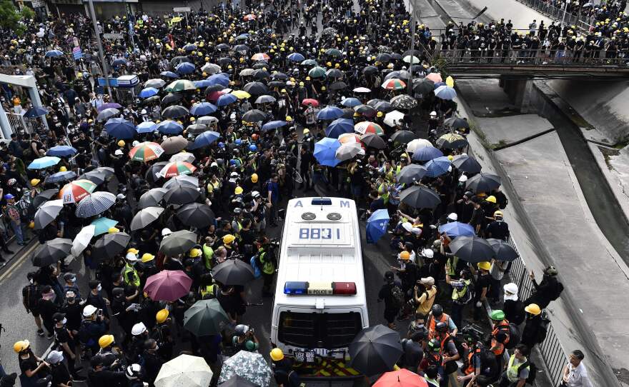 A crowd of protesters blocks a police van during a demonstration on Saturday.