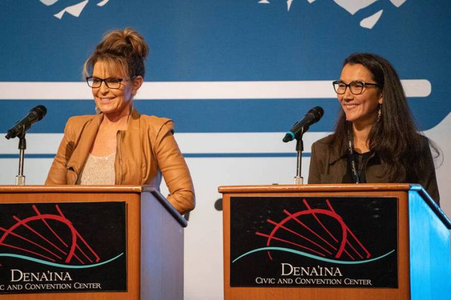 Sarah Palin, left, and Mary Peltola stand on stage before a U.S. House candidate forum at the Alaska Oil and Gas Association conference on Wednesday.