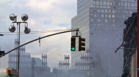"New York City, USA - September 29, 2001: The World Trade Center site at Ground Zero, debris and vehicles seen spread around the area already 2 weeks after the September 11, 2001 disaster. Fires are still burning underground and smoke and haze fills the sky."