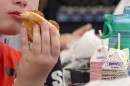 In this image from video, a student eats a meatball sub sandwich during lunch in Parkersburg, W.Va., on Wednesday, July 9, 2025.