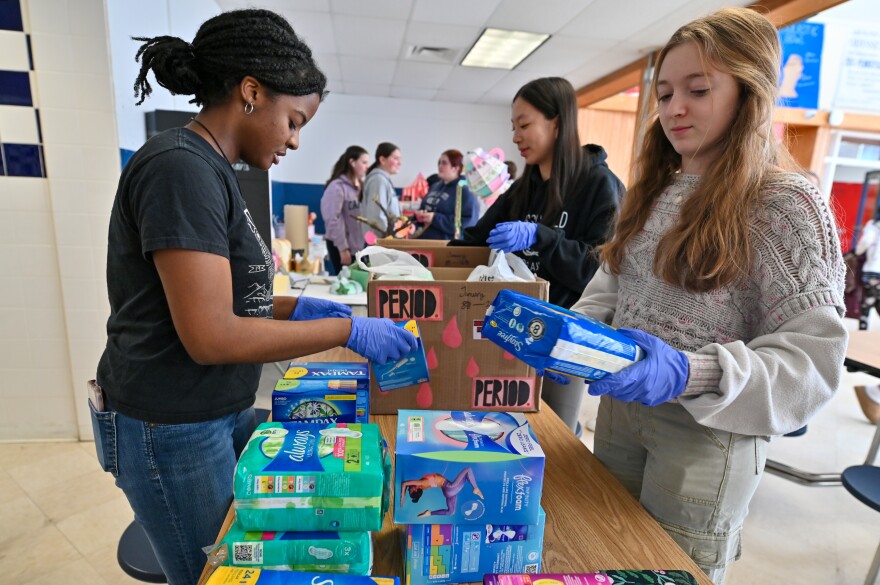 Abington Heights Period club members, including senior Noor Rutty, junior Chloe Dong and sophomore Elise Phillips, organize donated tampons and pads to be divided into packages for women in need.