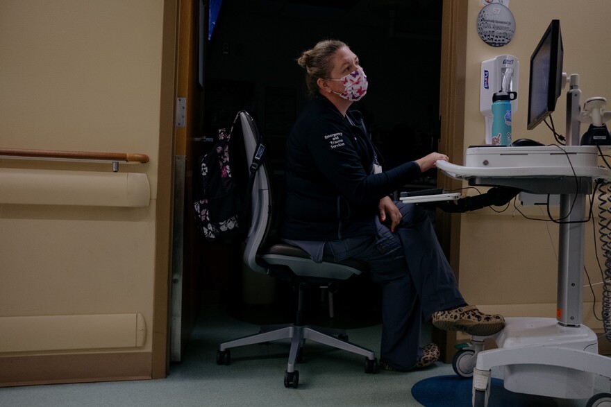 EMT Amy Saltzman works as a sitter, keeping an eye on a young behavioral-health patient in a 12-hour shift at the Sparrow Hospital Pediatric Emergency Department in Lansing.