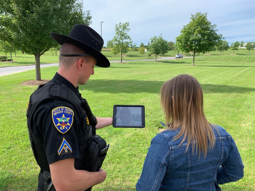 Ontario County Sheriff Deputy Jim Baker simulates a call to Rochester Regional Health's Comprehensive Psychiatric Evaluation Program using an iPad as part of a pilot program to connect people in crisis to mental health professionals.