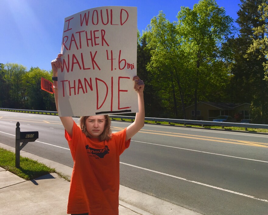 Valerie Timberlake and others walked nearly 5 miles from East Chapel Hill High to Franklin Street while passing cars honked in favor of gun control legislation.