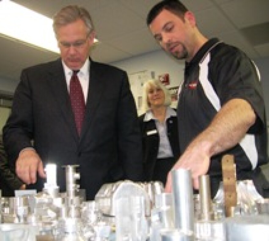 Governor Jay Nixon( D, Mo.) views student work at MCC Tech Center. Staff observe.