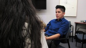 Claudia Pineda, right, interprets for a woman who suffered domestic abuse from her 13-year-old son.