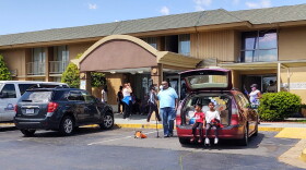 Long-term residents at the Days Inn on East Woodlawn Road waited for the water and electricity to be turned back on at midday Tuesday. 