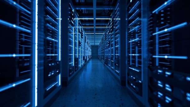 An artistic photo showing a row full of data servers with soft blue light