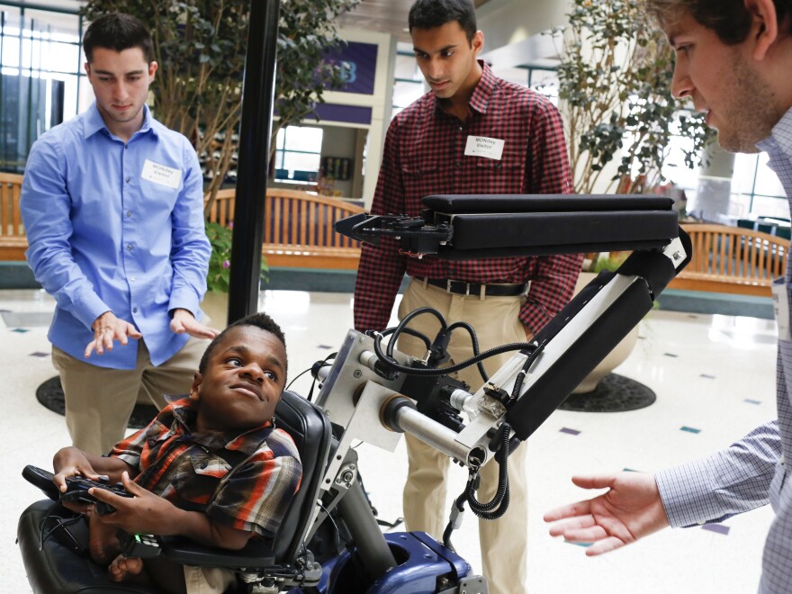 Najoomi (from left), Mittal and Sergio Gonzalez started working on the robotic arm two years ago.