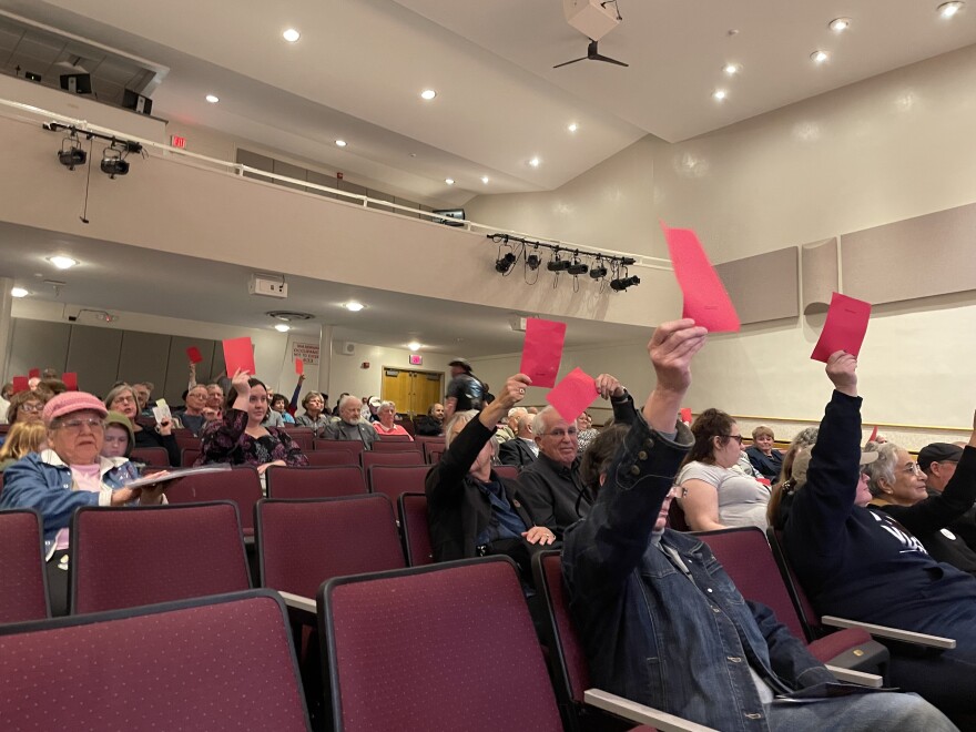 Some attendees held up red cards that read "disagree" as the congressman spoke about his stance on the Second Amendment.