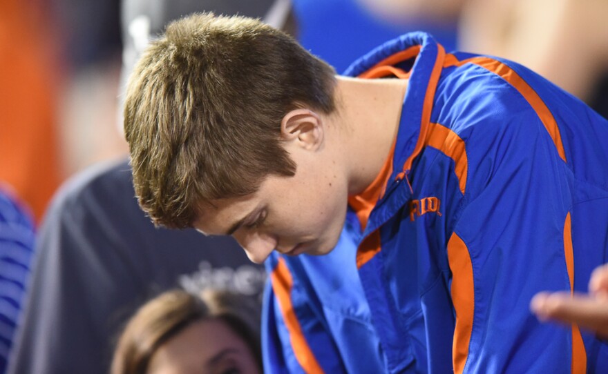 A Florida fan hangs his head in the fourth quarter as his team struggles to put points on the board. (Greenberry Taylor/ WUFT News)