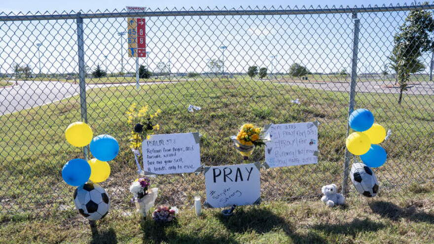 A memorial in front of the main gate at Stryker Sports Complex on Sunday. One child and one adult were killed, and multiple people were injured when a truck drove into a crowd at a youth soccer game and the children at the memorial witnessed it.