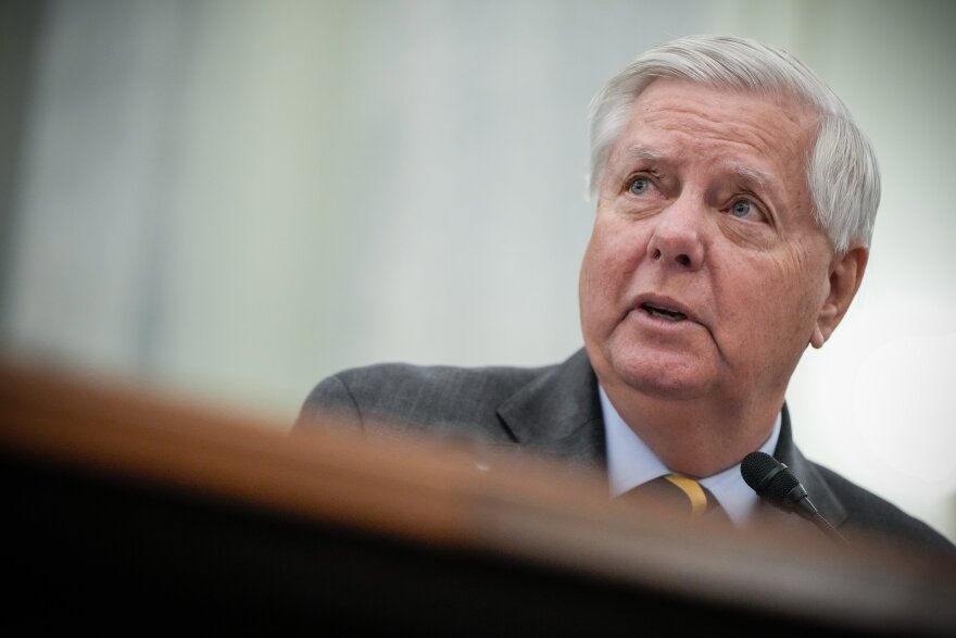 FILE - Sen. Lindsey Graham, R-S.C., introduces Adm. Kevin Lunday, acting commandant of the U.S. Coast Guard, during a Senate Commerce, Science and Transportation Committee hearing on the nomination Lunday for Commandant of the Coast Guard, Nov. 19, 2025, on Capitol Hill in Washington. (AP Photo/Julia Demaree Nikhinson, File)