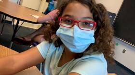 A student in the North Kansas City Schools wears a face mask on the first day of summer school. The Centers for Disease Control and Prevention recommend masks for children younger than 2, and pediatricians say wearing masks will help with social distancing in schools. 