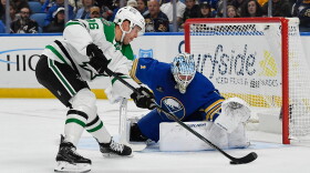 Dallas Stars right wing Mikko Rantanen, left, skates the puck in against Buffalo Sabres goalie Ukko-Pekka Luukkonen, right, during the second period of an NHL hockey game Thursday, Oct. 8, 2026, in Buffalo, N.Y. (AP Photo/Adrian Kraus)