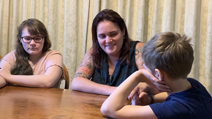 Agatha Walston talks with her two children.