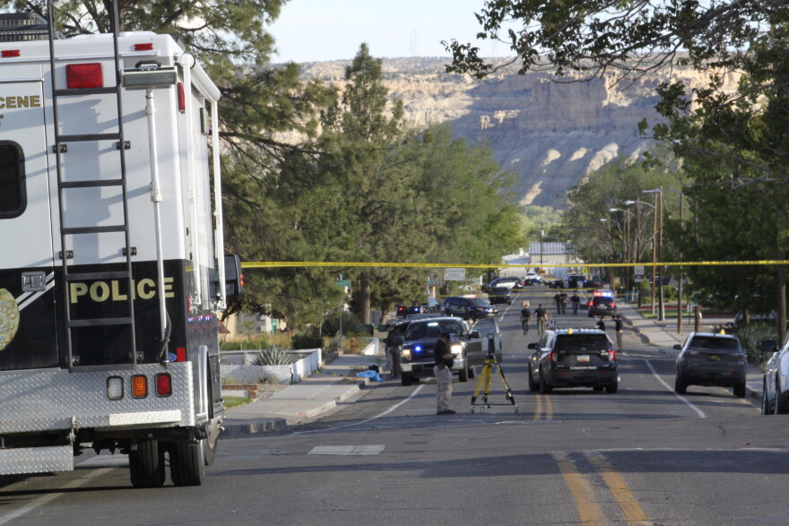Investigators work along a residential street following a deadly shooting Monday, May 15, 2023, in Farmington, N.M. Authorities said an 18-year-old opened fire in the northwestern New Mexico community, killing multiple people and injuring others, before law enforcement fatally shot the suspect.