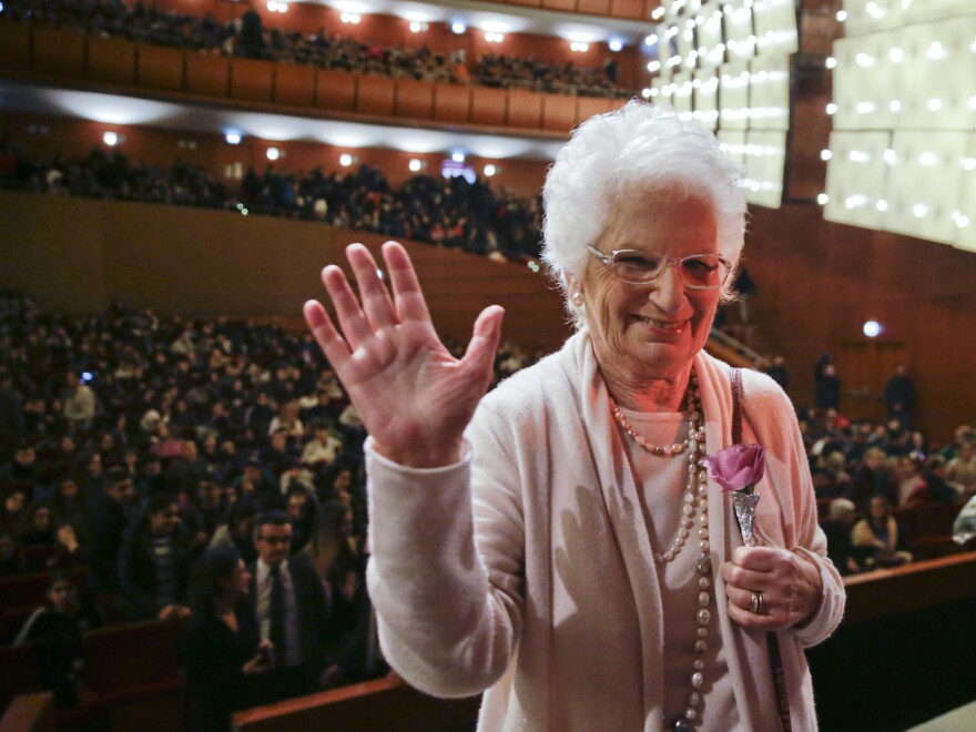 Liliana Segre waves at the end of a meeting with students in Milan, Italy, in 2018. For decades, Segre, 89, was reluctant to discuss her time in the Auschwitz concentration camp. But in the 1990s, she began speaking to schoolchildren throughout Italy about the Holocaust.