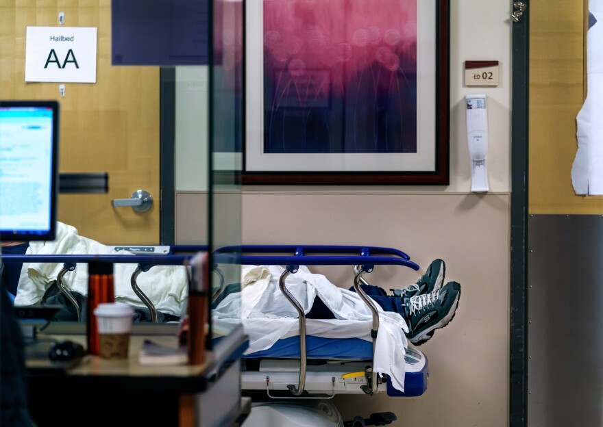 A health care worker stands ready with a stethoscope.  