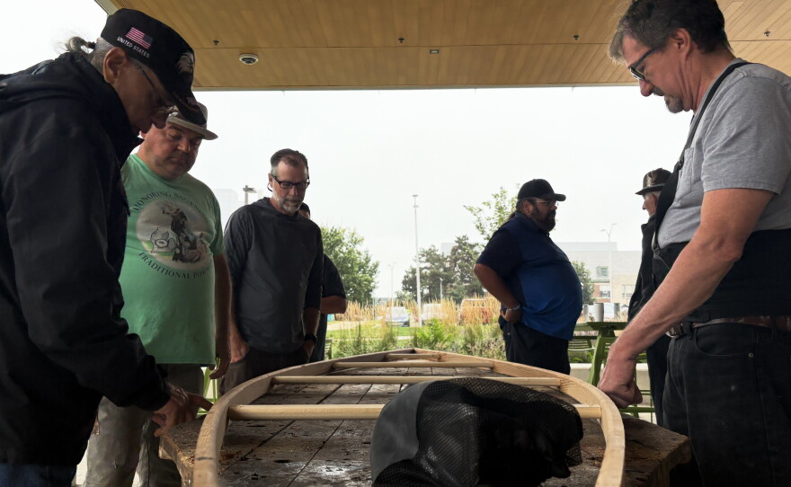Ron J. Paquin, his apprentices and volunteers building the birch canoe.