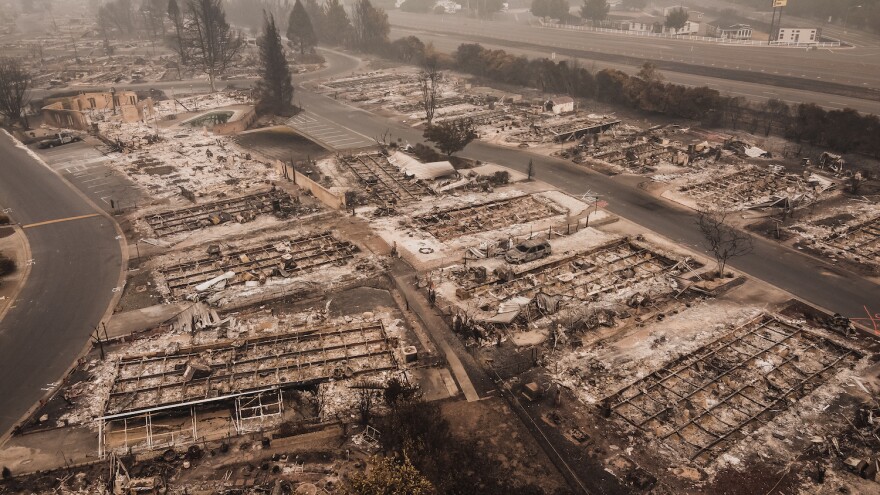 Smoke filled skies overlooking the aftermath and tragedy of a wildfire that blew through a Colorado town. As many as 80% of the homes lost to wildland fires could have been saved if their owners had followed a few simple fire-safe practices.