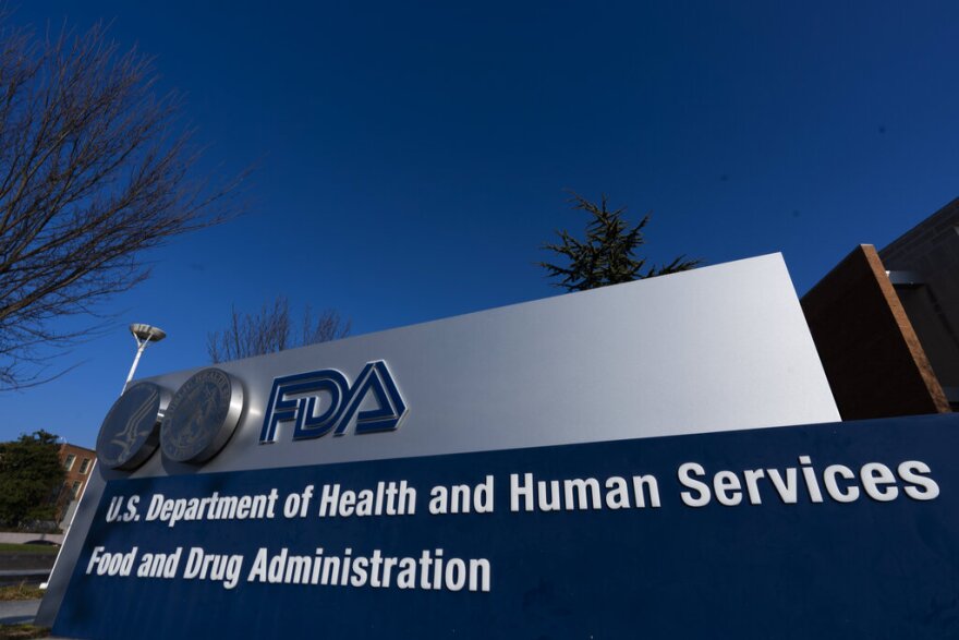 A blue and silver sign for the U.S. Department of Health and Human Services Food and Drug Administration building is shown in Silver Spring, Md.  