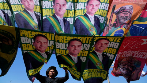 A street vendor sells campaign flags of presidential candidates Sen. Flavio Bolsonaro and current President Luiz Inacio Lula da Silva who is running for reelection in Brasilia, Brazil, Tuesday, Sept. 29, 2026. 